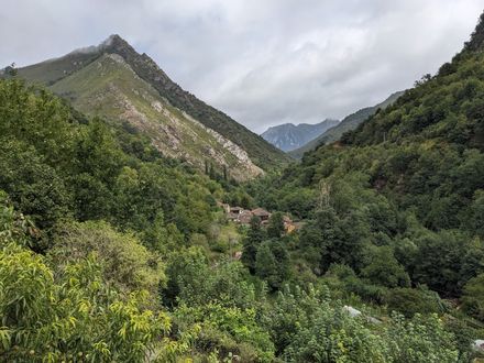 Inside the Somiedo Natural Park, Asturias A picturesque valley showcasing majestic mountains and lush forests, creating a serene and captivating landscape